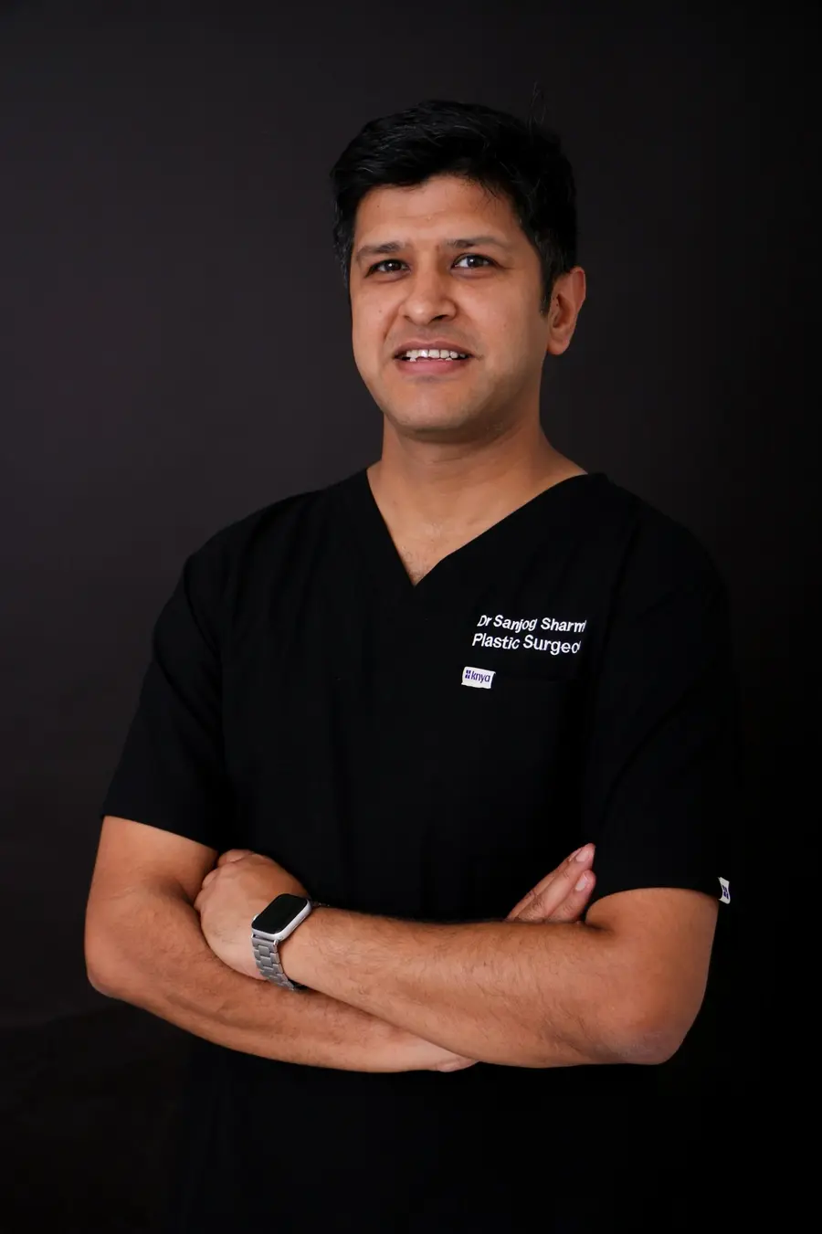 Dr Sanjog Sharma, plastic surgeon, in black scrubs