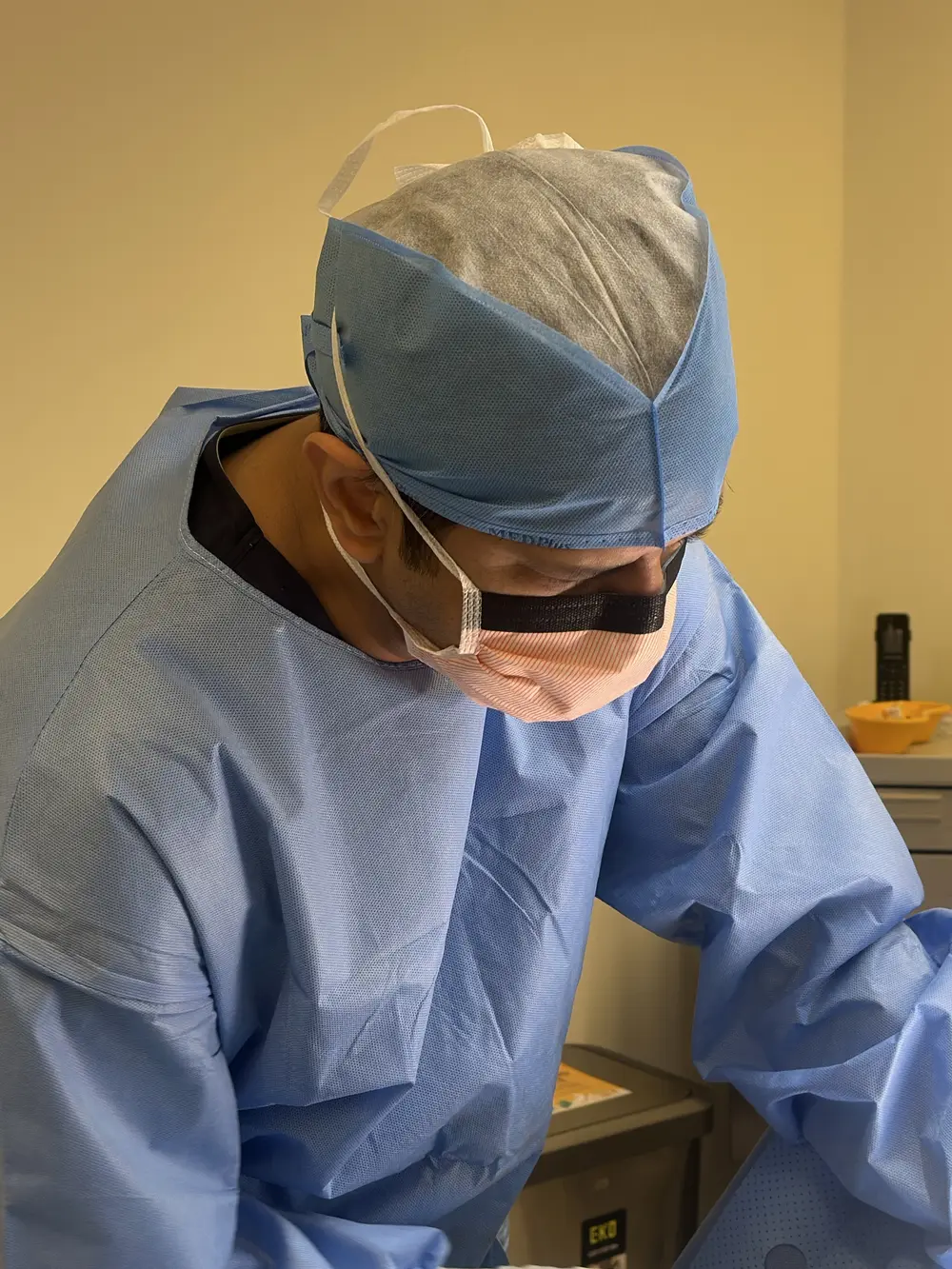 Dr Sanjog Sharma operating, wearing surgical loupes