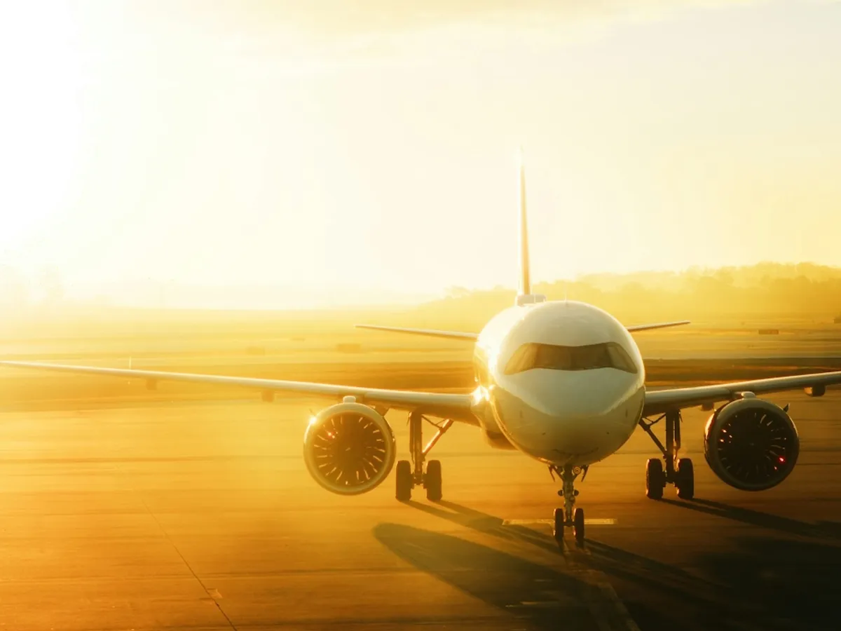 An aircraft on the tarmac at sunrise