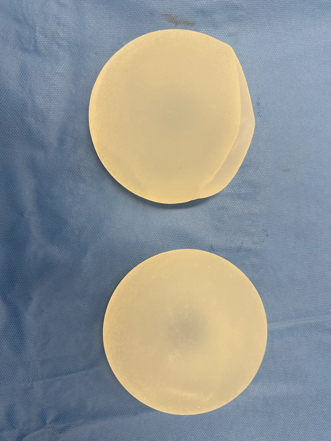 Breast implants of different base width and projection shown side by side for breast augmentation size planning