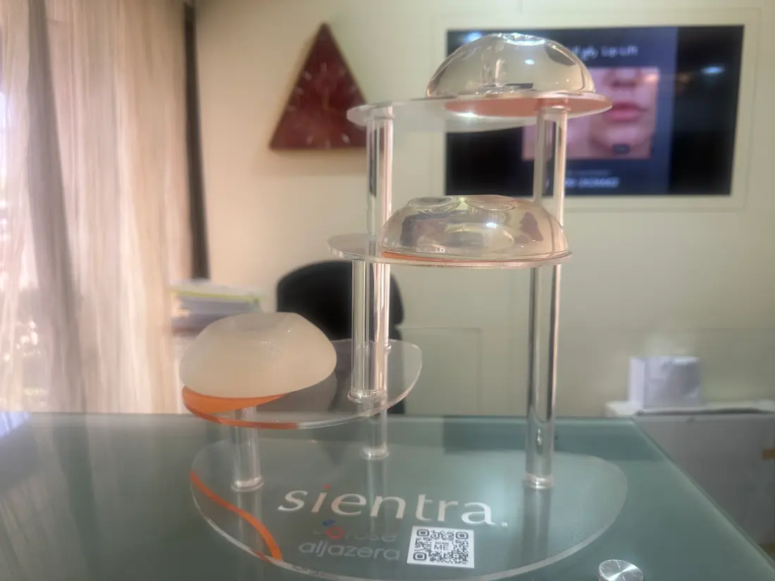 Surgical bra sizer trial during a breast augmentation consultation to compare implant volumes